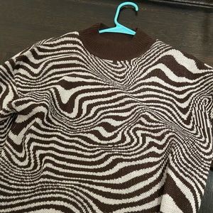 A brown and white sweater old sweater.